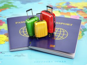 Passport and suitcases on the world map.