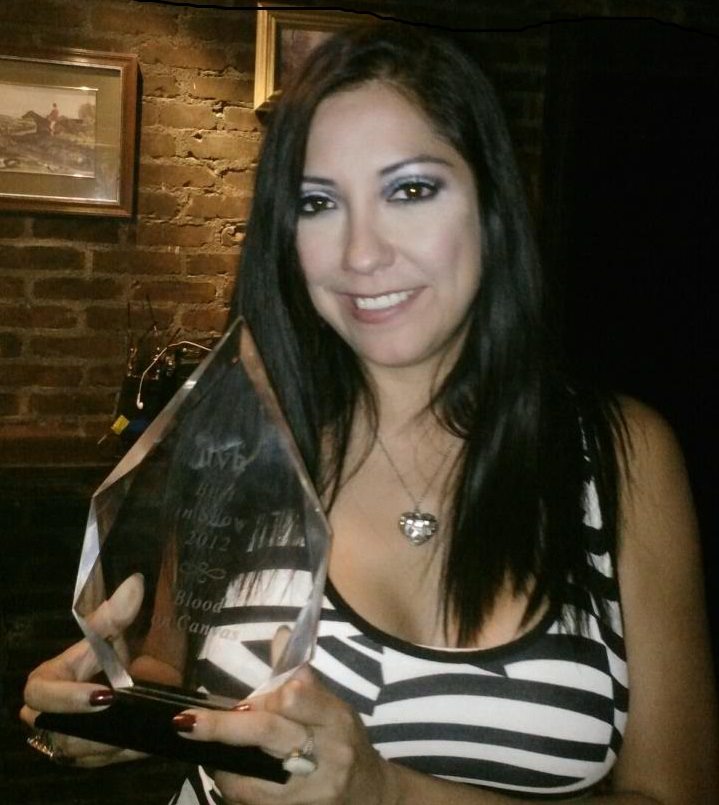 Renee Garcia with Award for "Blood on Canvas"
